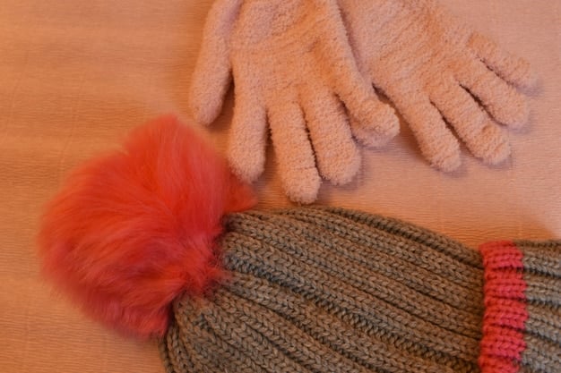 Close-up shot of a woman's hands showcasing a collection of affordable winter accessories like colorful scarves, woolen gloves, and stylish hats.