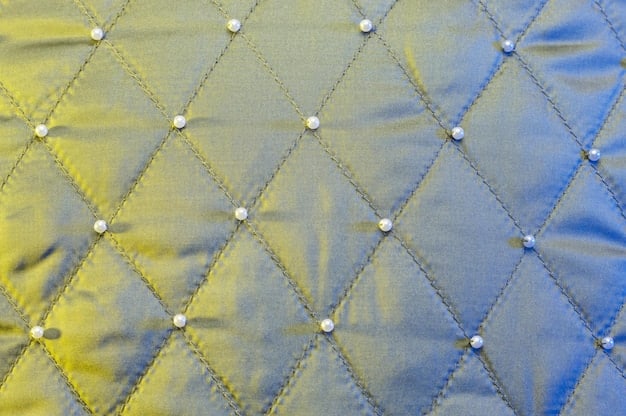 A close-up shot of different textures and patterns of quilted fabric, ranging from classic diamond patterns to modern abstract designs. Focus on the stitching and the variety of materials used, like nylon, velvet, and recycled polyester.