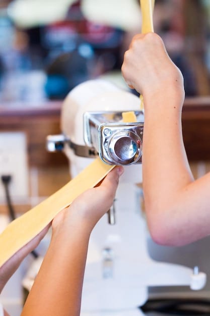 A close-up shot of hands working on a sewing machine in a brightly lit workshop. The hands are carefully guiding a piece of organic cotton fabric, showcasing the craftsmanship and attention to detail in sustainable garment production. The background includes spools of thread in natural colors and partially finished garments, emphasizing the process of ethical fashion creation.