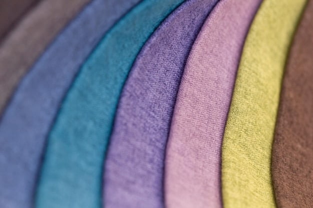 A close-up shot of various fabric swatches displaying different prints and color combinations. The swatches range from bold floral patterns to subtle geometric designs, showcasing the textures and colors. The image is well-lit with a focus on the details in a fashion designer's studio.