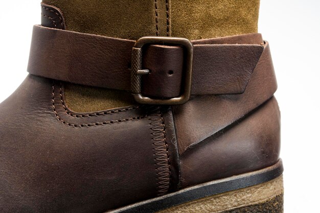 A close-up shot of brown leather Chelsea boots, showcasing the elastic side panel and leather texture. The boots are clean and well-maintained.