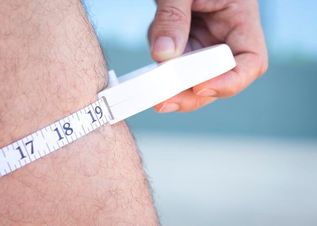 A close-up of a measuring tape showing the measurement around a man's waist. The tape measure is held taut and the numbers are clearly visible. The background is blurred.