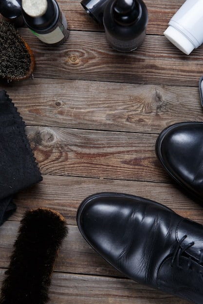 A man polishing his leather shoes with a polishing cloth. The background shows a collection of shoe care products, including polish, brushes, and cloths, arranged neatly on a shelf.