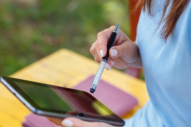 A close-up shot of a student using a digital pen on a tablet to take notes during a lecture. The tablet screen displays a complex diagram or a colorful presentation, highlighting the device's capability to handle detailed content.