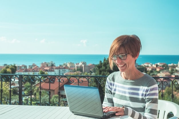 A professional working remotely from a sunny terrace in Barcelona, using a 5G-enabled laptop with a seamless video conference call interface.