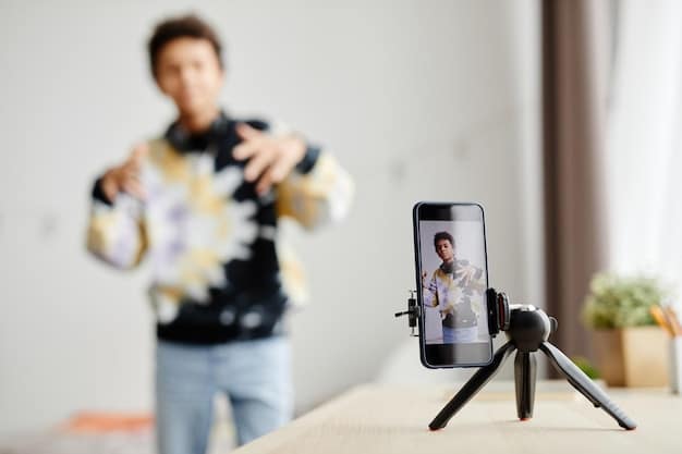 A smartphone attached to a small tripod with an external microphone plugged into it, set up for recording a video interview in a quiet indoor setting.