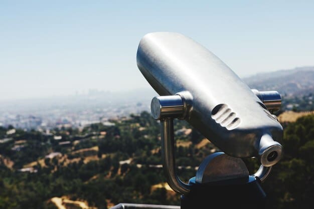 A close-up of a satellite messenger device displaying a message received, with an outdoor background showing a person hiking in a remote mountain area. The focus is on the device and the communication it enables in a location with no cell service.
