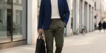 Man in chore jacket, knit polo, and pleat-front trousers